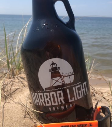 Harbor Light growler in sand